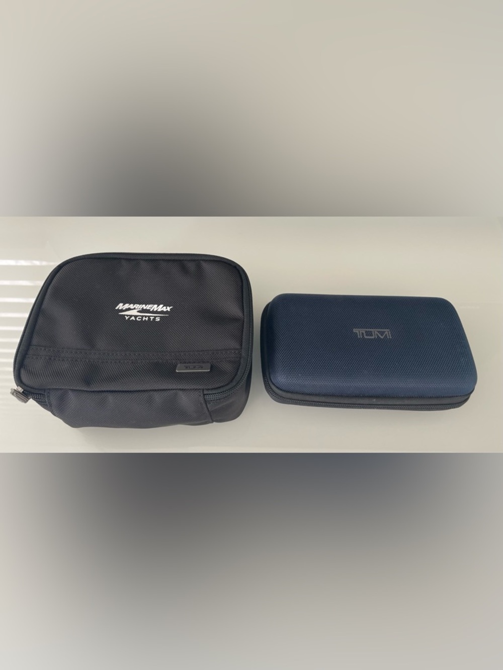 2 NEW Tumi toiletry cases.